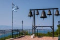 Bells and greek flag at Saint Patapios of Thebes monastery, Loutraki, Greece.